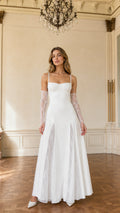 Front view of model wearing white bustier maxi gown with lace insets and lace gloves