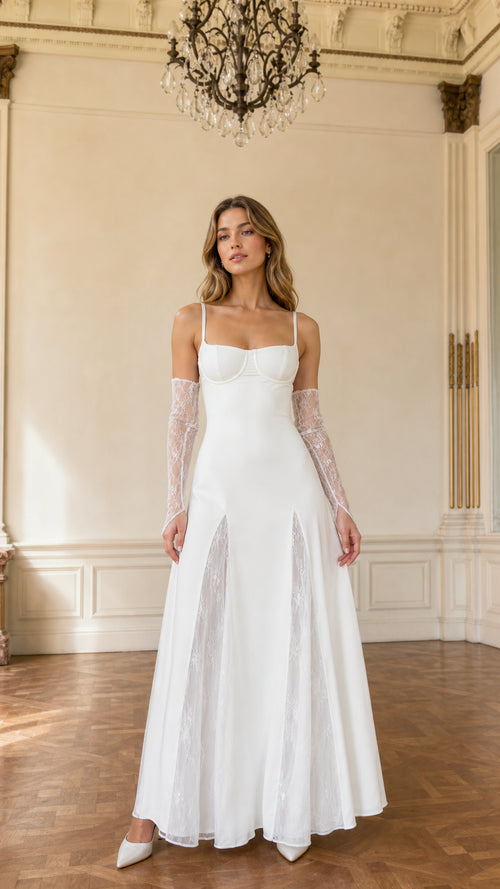Front view of model wearing white bustier maxi gown with lace insets and lace gloves