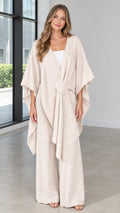 Front view of woman wearing beige draped kimono poncho top and wide leg pants set