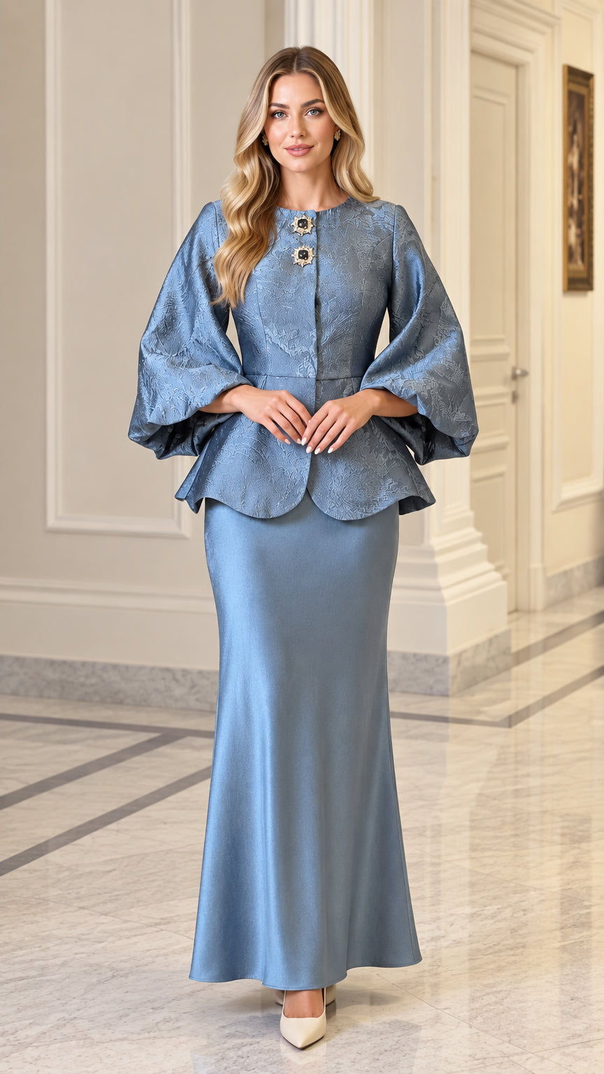 Front view of model wearing dusty blue jacquard peplum jacket and maxi skirt set