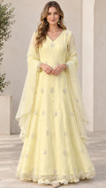 Full front view of model wearing pastel yellow embroidered maxi dress with matching scarf