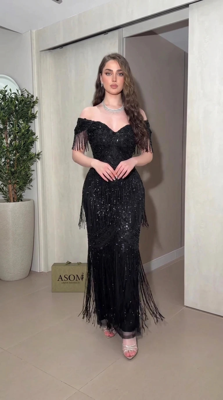 Front view of black off-the-shoulder beaded fringe evening gown
