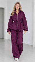 Women's plum purple drawstring peplum zip jacket and wide-leg pants two-piece set front view