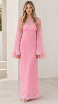 Front view of woman wearing pink sheer bell sleeve maxi dress with lace trim