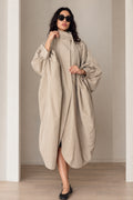 Front view of model wearing beige oversized cocoon duster coat with stand collar