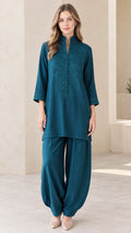 Front view of woman wearing Teal embroidered tunic and draped pant set