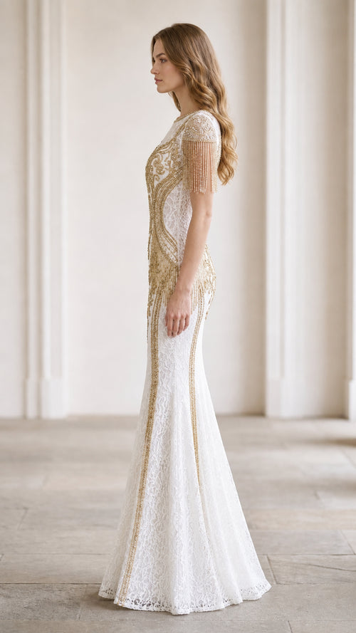 Side profile of white lace mermaid gown showing fitted silhouette and trailing beaded accents