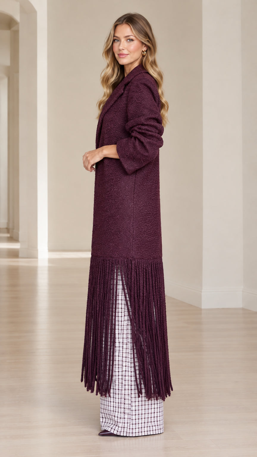 Side profile view of model wearing Burgundy fringe hem overcoat