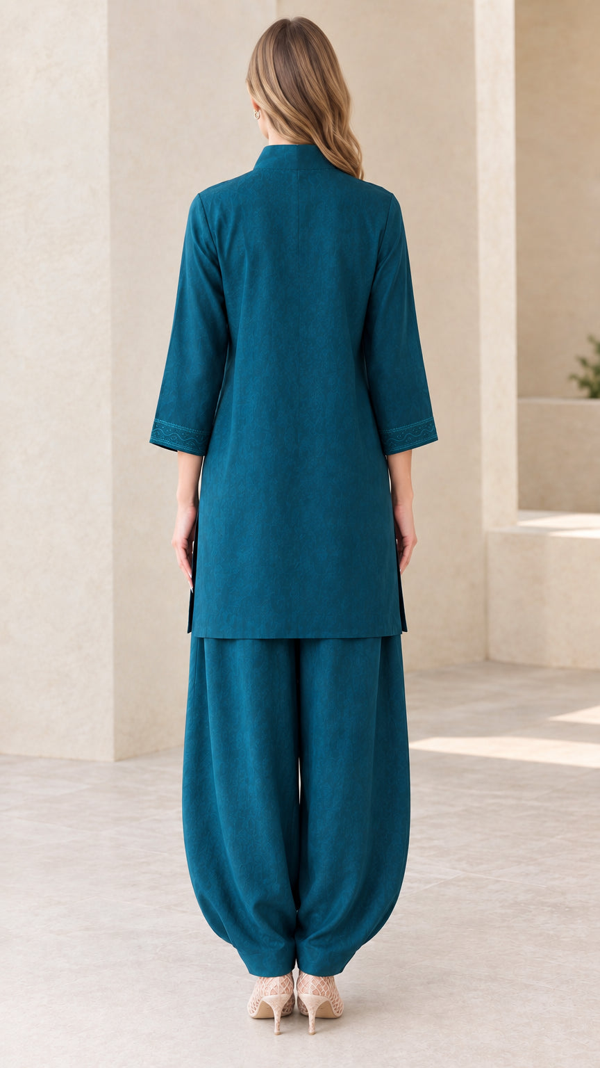 Back view of woman wearing Teal tunic and matching trousers
