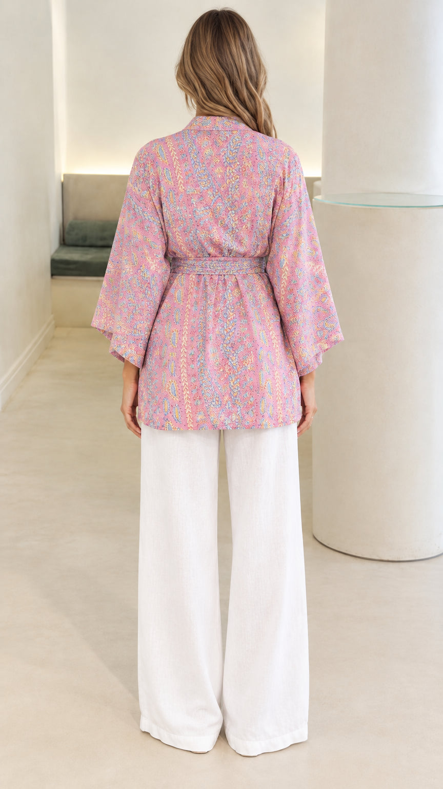 Back view of model wearing pink paisley print belted kimono top