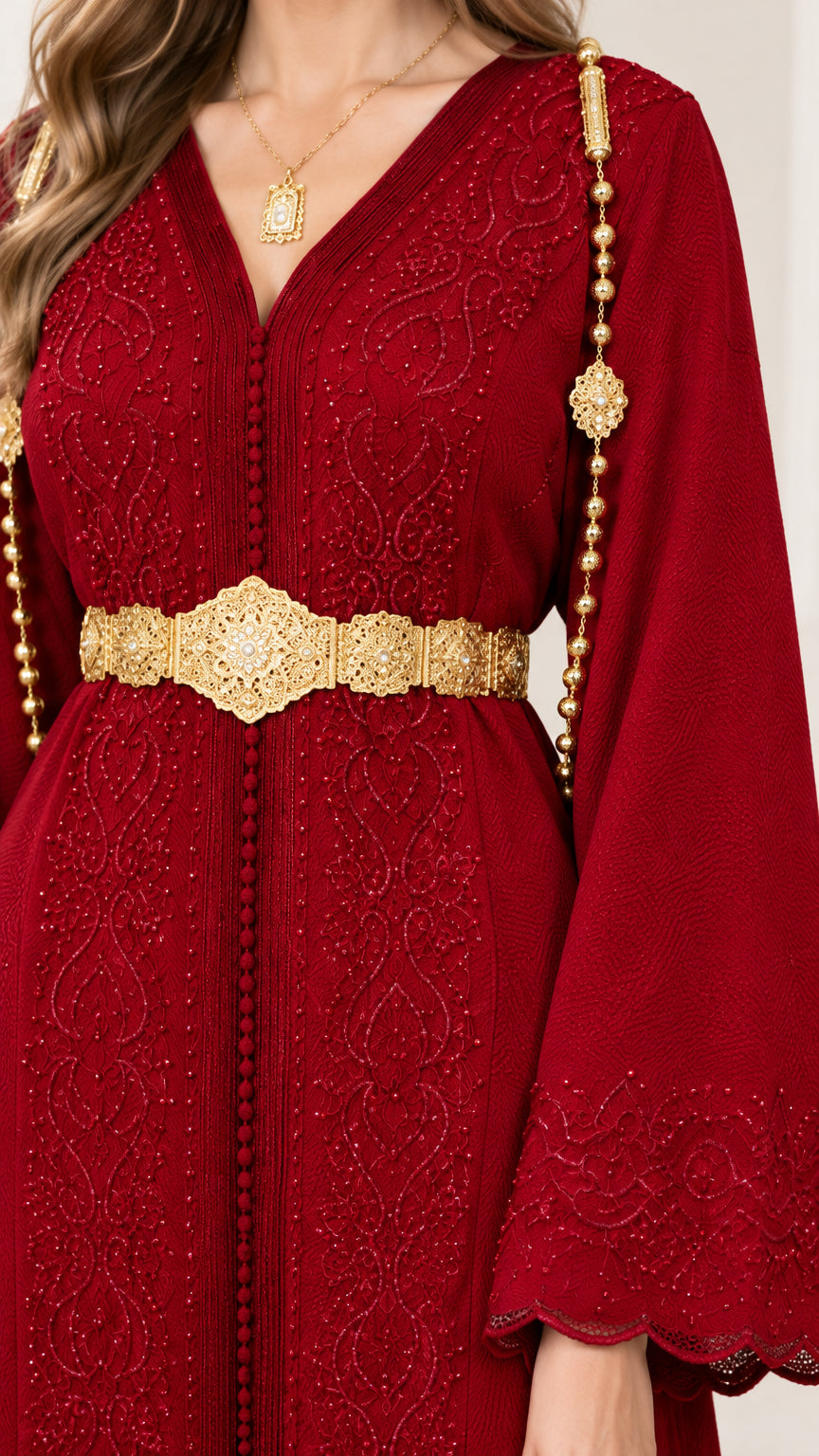 Close-up of intricate bodice embroidery and ornate gold belt on Wine Red dress