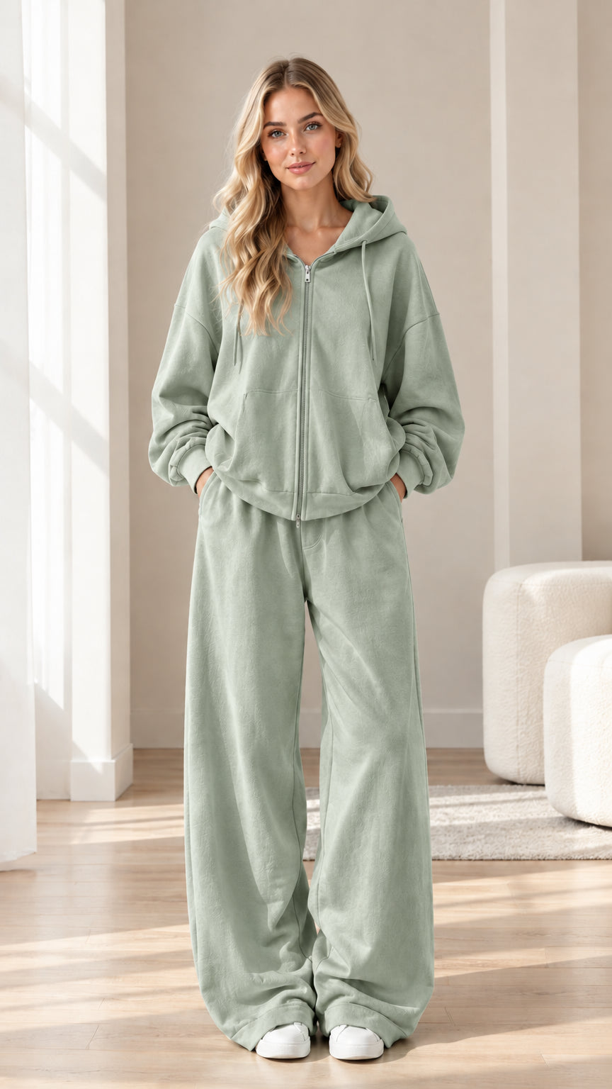 Woman wearing sage green zip-up hoodie and wide-leg sweatpants set