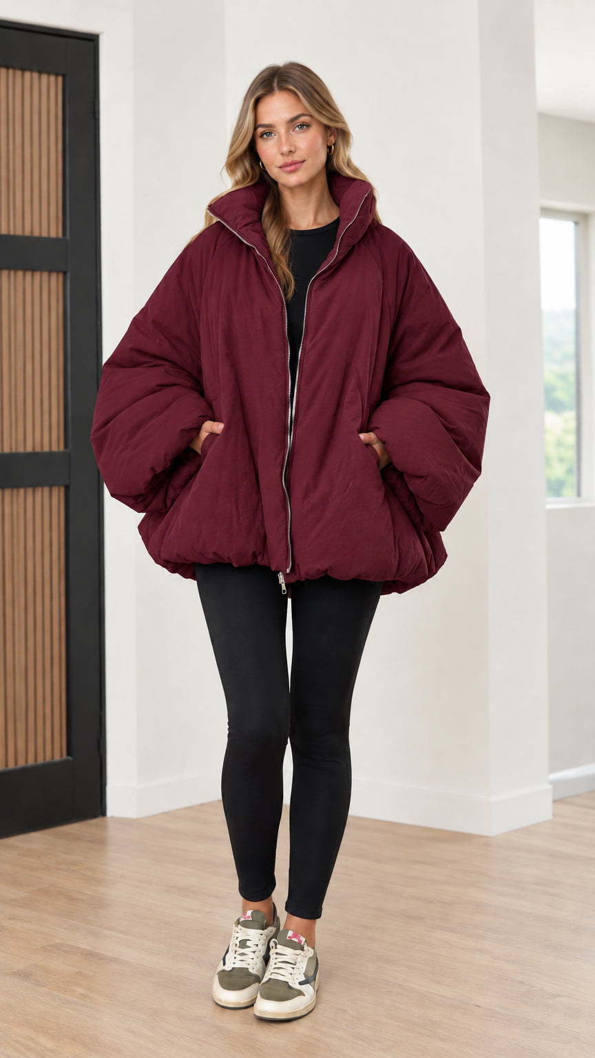 Model wearing deep burgundy red oversized stand collar puffer jacket