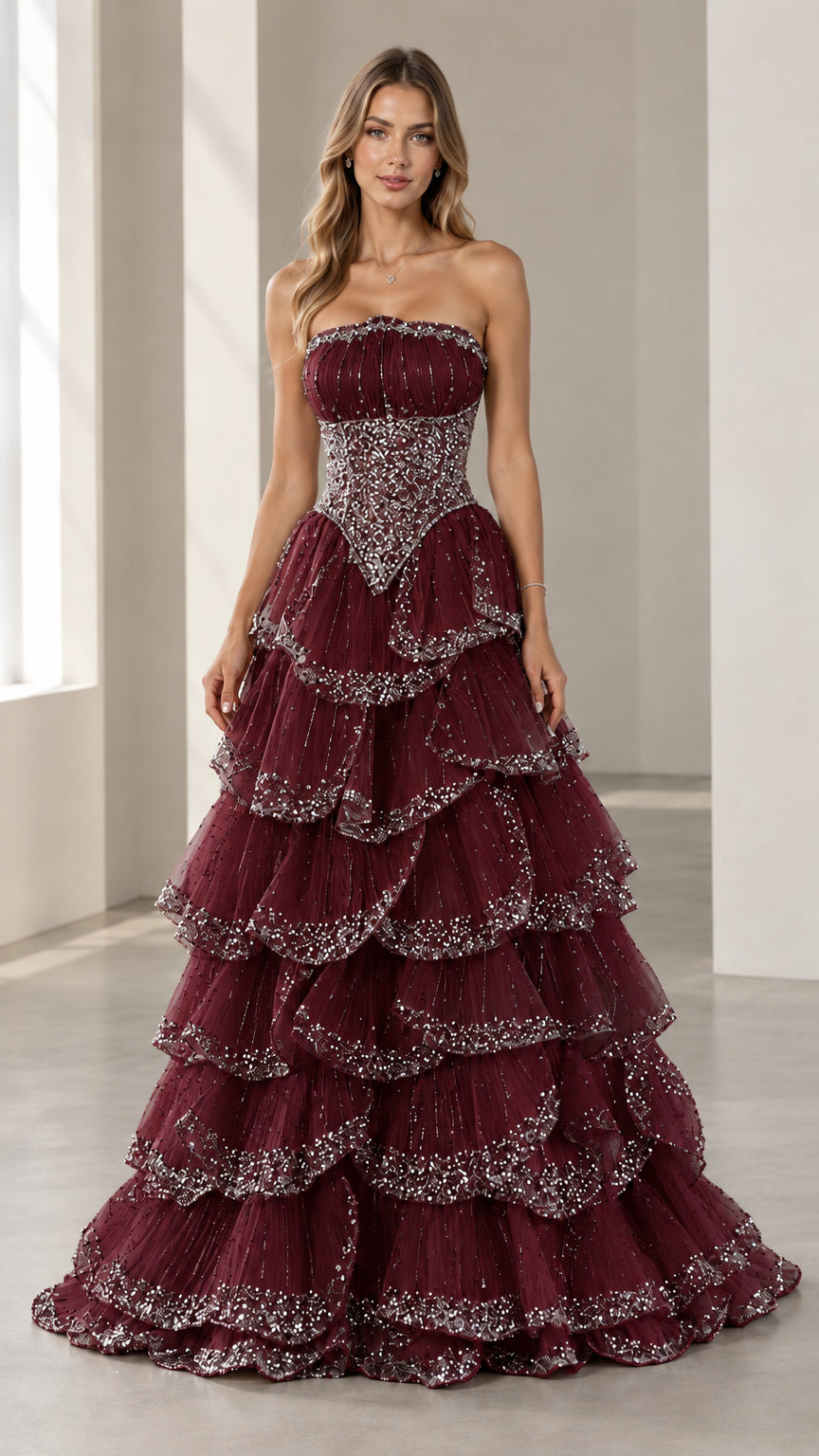 Full-length front view of the strapless beaded tiered evening gown in Burgundy
